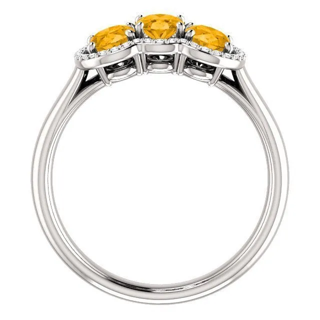 14KT GOLD 1.32 CTW CITRINE & 0.10 CTW DIAMOND 3 STONE OVAL HALO RING