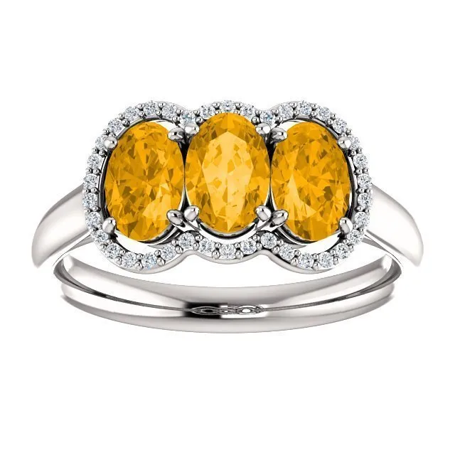 14KT GOLD 1.32 CTW CITRINE & 0.10 CTW DIAMOND 3 STONE OVAL HALO RING